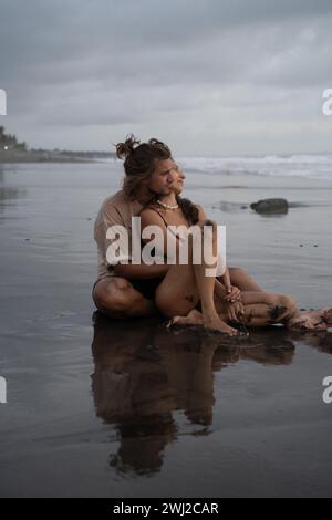 Young cheerful happy couple in love on the beach. Bali Stock Photo