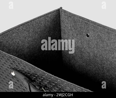 Closeup of black leather woven box with gray felt lining Stock Photo