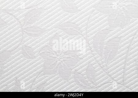 This image features a detailed close-up of a light gray textured vinyl wallpapers showcasing a intricate diagonal weave pattern with floral elements. Stock Photo