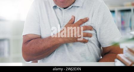 Man, hands and chest pain with heart, illness or cancer in discomfort, emergency or healthcare at hospital. Closeup of male person or patient with Stock Photo