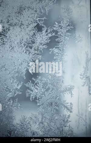 Frosted patterns on glass after a haw frost. Stock Photo