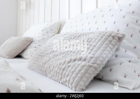White comfortable soft pillows on the bed Stock Photo