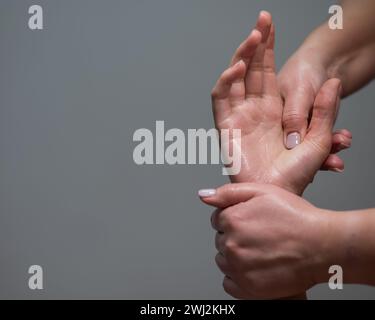 The masseuse massages the client's palms. Close-up of hands at a spa treatment. Copy space.  Stock Photo