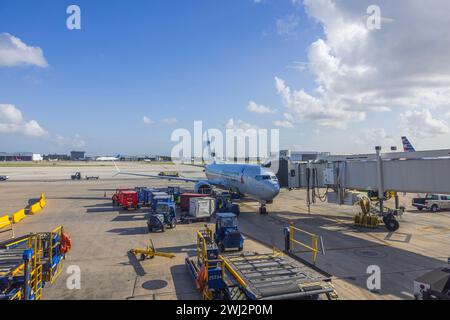 In Miami airport, there is a view of American Airlines plane connected to boarding ramp for passenger embarkation. Miami. USA. Stock Photo