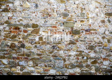 old painted brick wall, weathered and distressed paint peeling Stock Photo