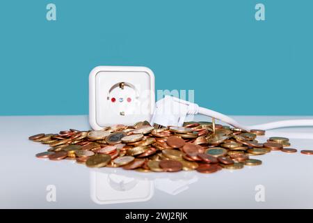 White european plug socket and electricity power plug lying in Heap of Euro money. on blue backgroun Stock Photo