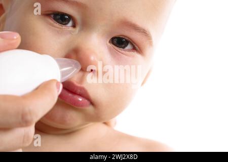 Mother using nasal aspirator on her child nose. Stock Photo