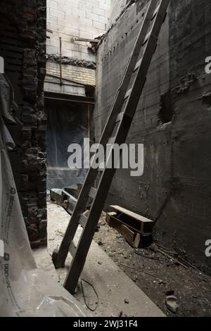 A wooden ladder leaning against a wall inside the Royal Connaught Hotel before renovations in Hamilton, Ontario, Canada Stock Photo