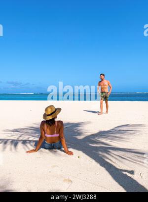 Man and Woman on a tropical beach in Mauritius, a couple on honeymoon vacation in Mauritius Stock Photo