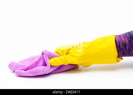 Microfiber cleaning cloth in woman hand. Surface home cleaning wearing medical yellow gloves. Saniti Stock Photo