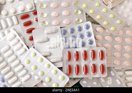 Heap of colored assorted medicine pills, tablets and Capsules. Antiviral capsule, pills in plastic Stock Photo