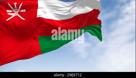 National flag of Oman waving in the wind on a clear day Stock Photo