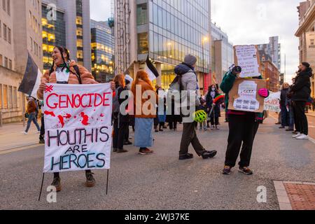 Leeds, UK. 12 FEB, 2024. Protestor stands outside Leeds train station with a 'Houthis are Heroes' banner. Credit Milo Chandler/Alamy Live News Stock Photo