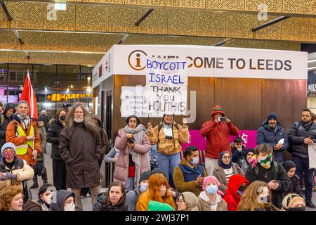 Leeds, UK. 12 FEB, 2024. Protestor holds 'Boycott Israel / Thank you Houthis' sign amongst other protestors at Leeds railway station  . Credit Milo Chandler/Alamy Live News Stock Photo