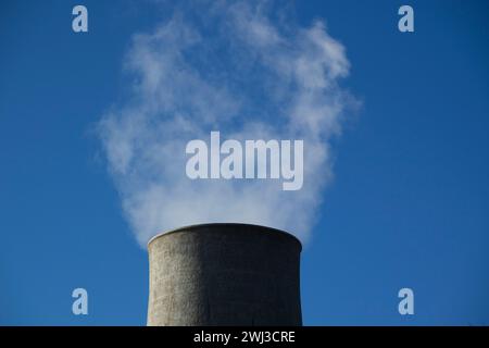 Photographic view of the steam cooling chimney coming from underground Stock Photo