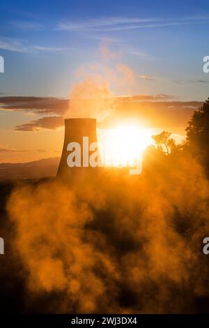 Photographic view of the steam cooling chimney at sunset Stock Photo