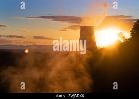 Photographic view of the steam cooling chimney at sunset Stock Photo