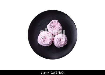Delicious fresh natural airy marshmallows on a black ceramic plate Stock Photo