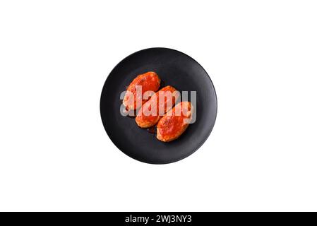 Meat cutlet or meatballs in tomato sauce with garlic, salt, spices and herbs Stock Photo