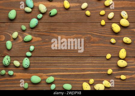 Frame made of painted Easter eggs on wooden background Stock Photo