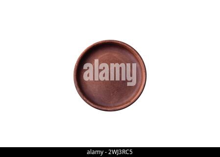 Empty brown colored ceramic plate on dark concrete background Stock Photo