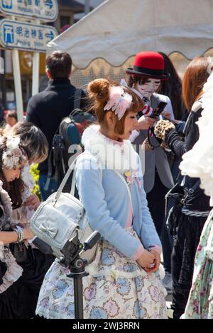 A girl dressed up in Harajuku wearing lolita style outfit with accessories and make up. Stock Photo