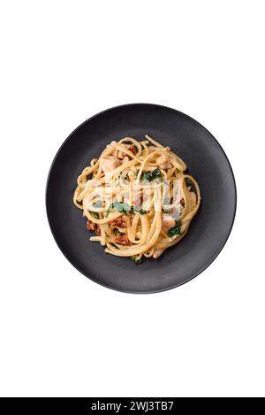Delicious pasta with spinach, sun dried tomatoes, cheese, onions Stock Photo