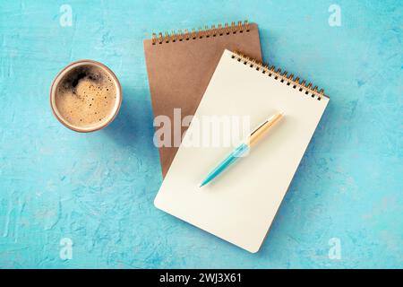 Notebook mockup with a pen and a cup of coffee, overhead flat lay Stock Photo