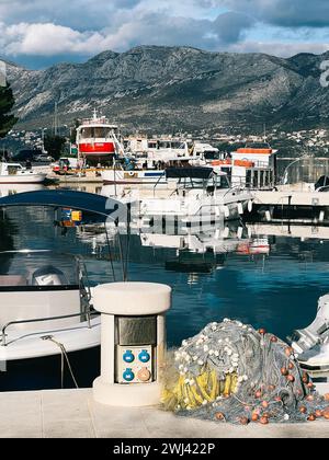 Shore power bollard on the pier with moored yachts Stock Photo