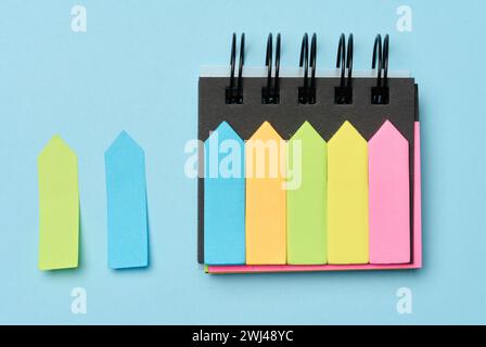 Multi-colored paper sticky notes on a blue background Stock Photo
