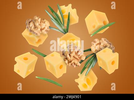 Cheese, walnuts and rosemary flying on brown background Stock Photo
