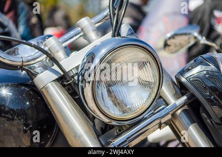 Chrome shiny chopper motorcycle headlight closeup Stock Photo