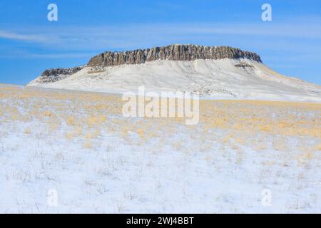 crown butte rising above the prairie in winter near simms, montana Stock Photo