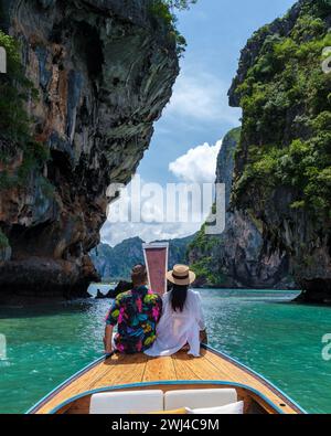 Asian woman and European man mid age on vacation in Thailand sitting in front of a longtail boat Stock Photo