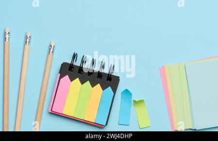 Multi-colored paper sticky notes on a blue background Stock Photo