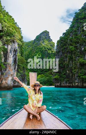Asian women in front of a longtail boat at Kho Phi Phi Thailand Stock Photo