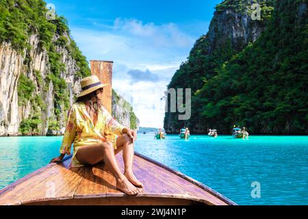 Asian women in front of a longtail boat at Kho Phi Phi Thailand Stock Photo