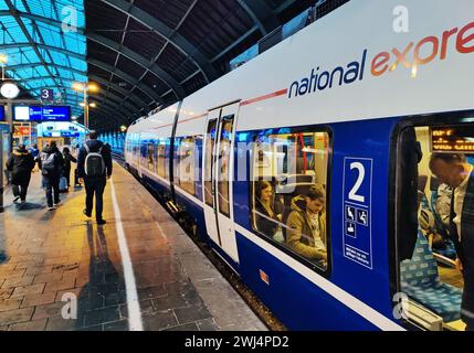 Local train of National Express on the platform in the early morning at the main station, Cologne Stock Photo