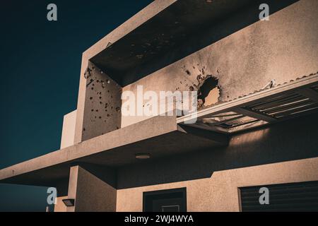 Bullet holes in concrete wall on building side Stock Photo