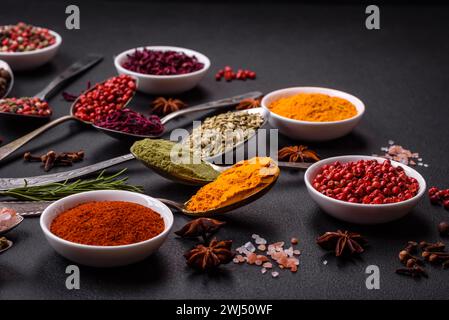 Composition consisting of variations of spices in white bowls and metal spoons Stock Photo