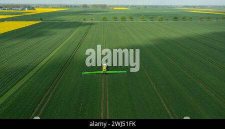 Tractor with field sprayer when applying pesticide against pesticide Stock Photo