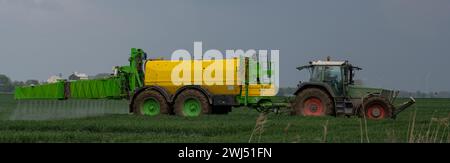 Tractor with field sprayer when applying pesticide against pesticide Stock Photo