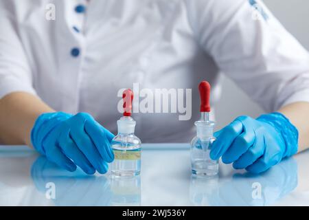 Doctor using pipette for taking samples for test in special chemical laboratory or clinic Stock Photo