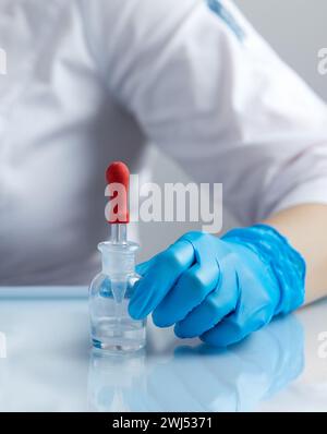 Doctor using pipette for taking samples for test in special chemical laboratory or clinic Stock Photo
