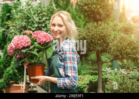 Gardeners working with flowers in garden center Stock Photo