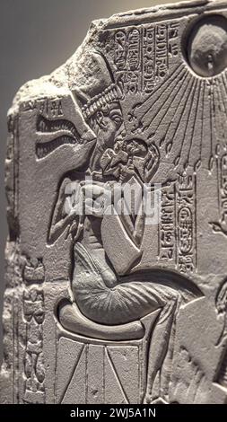 The Amarna period scene depicting the divine figure Aten with Akhenaten or Nefertiti below Stock Photo