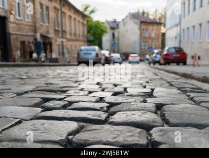 Close-up of glistening paving stones on an ancient street in the evening. Background is out of focus Stock Photo