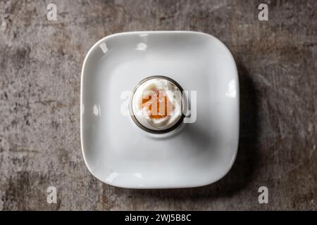 Soft-boiled egg in eggcup - top of view. Stock Photo