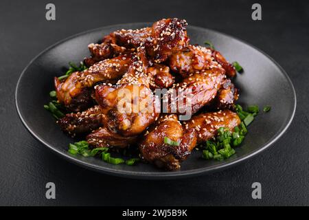 Delicious chicken wings with special marinade and sesame Stock Photo