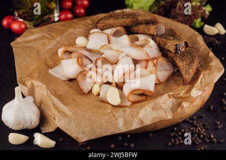 Ukrainian traditional food - sliced smoked lard on cutting board with garlic Stock Photo